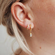 Iris hoops in gold with emerald cut charms and Virginia huggies in gold