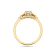 Emerald cut diamond buckle ring in yellow gold